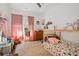 Cozy bedroom featuring bright window, hardwood floors, and stuffed animals on the bed at 642 Erin Sw Ave, Atlanta, GA 30310