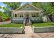 Charming green craftsman-style home with manicured front lawn and inviting front porch at 642 Erin Sw Ave, Atlanta, GA 30310
