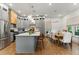 Well-lit kitchen with stainless steel appliances, large island, and adjacent dining table at 642 Erin Sw Ave, Atlanta, GA 30310