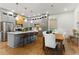 Open-concept kitchen with large island, stainless steel appliances, and adjacent dining area at 642 Erin Sw Ave, Atlanta, GA 30310