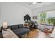 Bright living room featuring a comfortable couch, hardwood floors, and a well-equipped workspace at 642 Erin Sw Ave, Atlanta, GA 30310