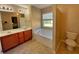 Well-lit bathroom featuring a large soaking tub and double sink vanity at 125 Redsage Rdg, Atlanta, GA 30349