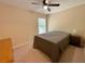 Neutral bedroom with carpet, a ceiling fan, and natural light filtering through the window at 125 Redsage Rdg, Atlanta, GA 30349