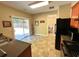 Well-lit kitchen featuring a sliding glass door to the backyard, black appliances, and a view of the dining area at 125 Redsage Rdg, Atlanta, GA 30349