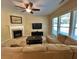 Comfortable living room with a fireplace, large windows, and neutral decor, creating a relaxing and inviting space at 125 Redsage Rdg, Atlanta, GA 30349