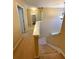 Well-lit staircase with neutral carpeting and white railing leading to an upstairs hallway with doorway at 125 Redsage Rdg, Atlanta, GA 30349