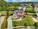 Aerial view of a beautiful home with a large yard and mature trees in a lush community at 1835 Henley Way, Alpharetta, GA 30009