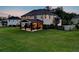 Home featuring a covered patio, green lawn, and a fenced perimeter at 1835 Henley Way, Alpharetta, GA 30009