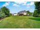 Expansive backyard with a covered patio, green lawn, and mature trees at 1835 Henley Way, Alpharetta, GA 30009