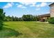 Spacious backyard featuring lush green lawn and a covered outdoor living area at 1835 Henley Way, Alpharetta, GA 30009