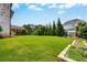 Large backyard with a covered patio, lawn, and planting beds at 1835 Henley Way, Alpharetta, GA 30009
