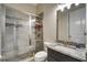 Modern bathroom with a tiled shower, granite countertops, and modern fixtures at 1835 Henley Way, Alpharetta, GA 30009