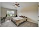 Comfortable bedroom with a large window, desk, and carpet flooring at 1835 Henley Way, Alpharetta, GA 30009