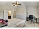Comfortable bedroom featuring a ceiling fan, ensuite bath, and a dedicated work space at 1835 Henley Way, Alpharetta, GA 30009