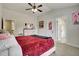 Bedroom with ensuite bath and ceiling fan with door leading out to the hallway at 1835 Henley Way, Alpharetta, GA 30009