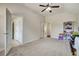 Large bedroom with ceiling fan, carpet, and a view into multiple rooms at 1835 Henley Way, Alpharetta, GA 30009