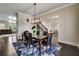 Elegant dining area featuring dark wood floors and open access to a living room at 1835 Henley Way, Alpharetta, GA 30009