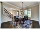 Formal dining room with dark hardwood floors and decorative lighting at 1835 Henley Way, Alpharetta, GA 30009