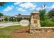 Community entrance sign with stone base, landscaping, and clear signage at 1835 Henley Way, Alpharetta, GA 30009