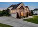 Beautiful two-story brick home with a well-manicured lawn and an attached two-car garage at 1835 Henley Way, Alpharetta, GA 30009