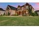 Beautiful two-story home with stone and brick exterior, well-maintained lawn and manicured landscaping at 1835 Henley Way, Alpharetta, GA 30009
