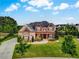 Beautiful two-story home with stone and brick exterior, black roof, and a front yard at 1835 Henley Way, Alpharetta, GA 30009