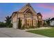 Beautiful two-story home with stone and brick exterior, a manicured lawn and a driveway at 1835 Henley Way, Alpharetta, GA 30009