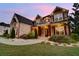 Beautiful two-story home with stone and brick exterior and a beautifully landscaped front yard at 1835 Henley Way, Alpharetta, GA 30009