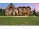 Charming two-story home with a well-manicured lawn and beautiful stone and brick exterior at 1835 Henley Way, Alpharetta, GA 30009