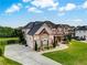 Attractive two-story brick home with a well-kept lawn and an attached two-car garage at 1835 Henley Way, Alpharetta, GA 30009