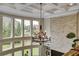 Open foyer featuring a coffered ceiling, stone accent wall, and large windows overlooking the green backyard at 1835 Henley Way, Alpharetta, GA 30009