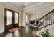 Welcoming foyer with wood floors, decorative glass doors, and views to the dining room at 1835 Henley Way, Alpharetta, GA 30009