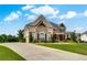Charming stone home featuring an expansive lawn, manicured landscaping, and a welcoming front entrance at 1835 Henley Way, Alpharetta, GA 30009