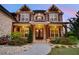 Close-up of a stone home featuring a welcoming front entrance and manicured landscaping at 1835 Henley Way, Alpharetta, GA 30009