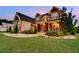 Charming stone home featuring an expansive lawn, manicured landscaping, and a welcoming front entrance at 1835 Henley Way, Alpharetta, GA 30009