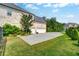 Side view of the brick home featuring a two-car garage and a large, well-maintained lawn at 1835 Henley Way, Alpharetta, GA 30009