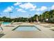 Community hot tub with surrounding lounge chairs and tables, umbrellas, and manicured greenery at 1835 Henley Way, Alpharetta, GA 30009