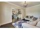 Bright living room with dark floors, crown molding, and view of the staircase at 1835 Henley Way, Alpharetta, GA 30009