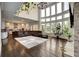 Bright living room adjacent to kitchen featuring fireplace, high ceilings, and big windows at 1835 Henley Way, Alpharetta, GA 30009