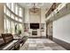 Large living room with a fireplace, tall ceilings, and plenty of natural light at 1835 Henley Way, Alpharetta, GA 30009
