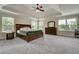 Spacious main bedroom with tray ceiling, fan and carpet, plus large windows offering plenty of natural light at 1835 Henley Way, Alpharetta, GA 30009