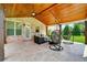This outdoor patio features ceiling fans, an outdoor sitting area and hanging swing chairs at 1835 Henley Way, Alpharetta, GA 30009