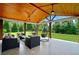 Inviting covered patio with ceiling fans, comfortable seating, and view of the backyard at 1835 Henley Way, Alpharetta, GA 30009