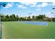 Well-maintained community tennis courts with vibrant blue and green surfaces, surrounded by mature trees and landscaping at 1835 Henley Way, Alpharetta, GA 30009