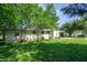 Expansive backyard featuring lush greenery surrounding the charming exterior of this single-story home at 2155 Rosedale Rd, Snellville, GA 30078