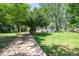 A long driveway leads to this cozy home surrounded by mature shade trees and a spacious front yard at 2155 Rosedale Rd, Snellville, GA 30078