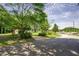 Street view of the property showcasing the home on a corner lot surrounded by mature trees and lush landscape at 2155 Rosedale Rd, Snellville, GA 30078