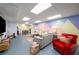 Finished basement with colorful accent wall, cozy seating area, and dining area at 117 Franklin Rd, Woodstock, GA 30188