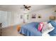 Bedroom with neutral colored walls, carpet flooring and a queen bed with blue comforter at 117 Franklin Rd, Woodstock, GA 30188