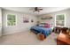 Bright bedroom featuring a ceiling fan, two windows and decoratively themed accents at 117 Franklin Rd, Woodstock, GA 30188